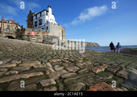 Jetty at low tide and village of Robin Hood`s Bay, North Yorkshire, England, United Kingdom, Europe Stock Photo